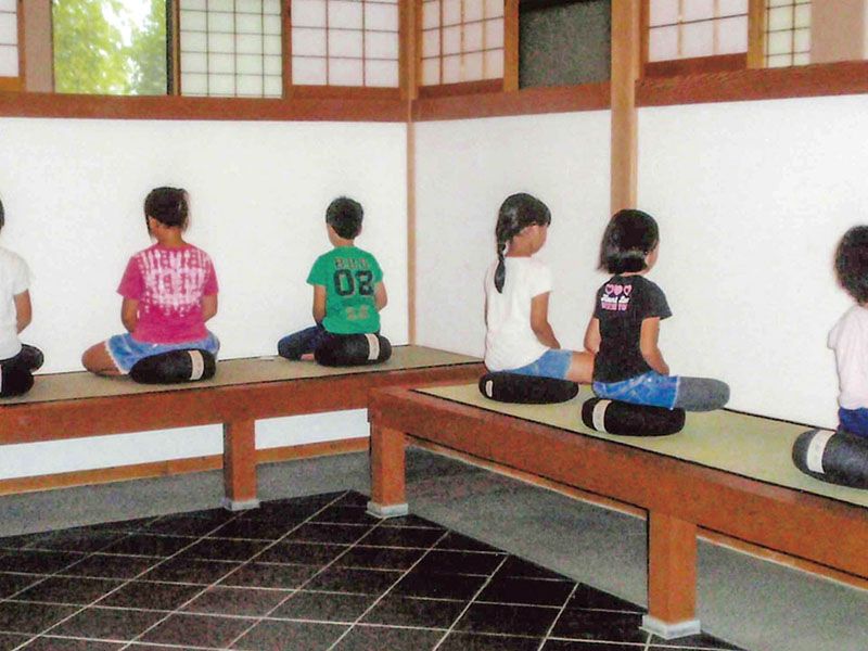 堂内で座る参拝者